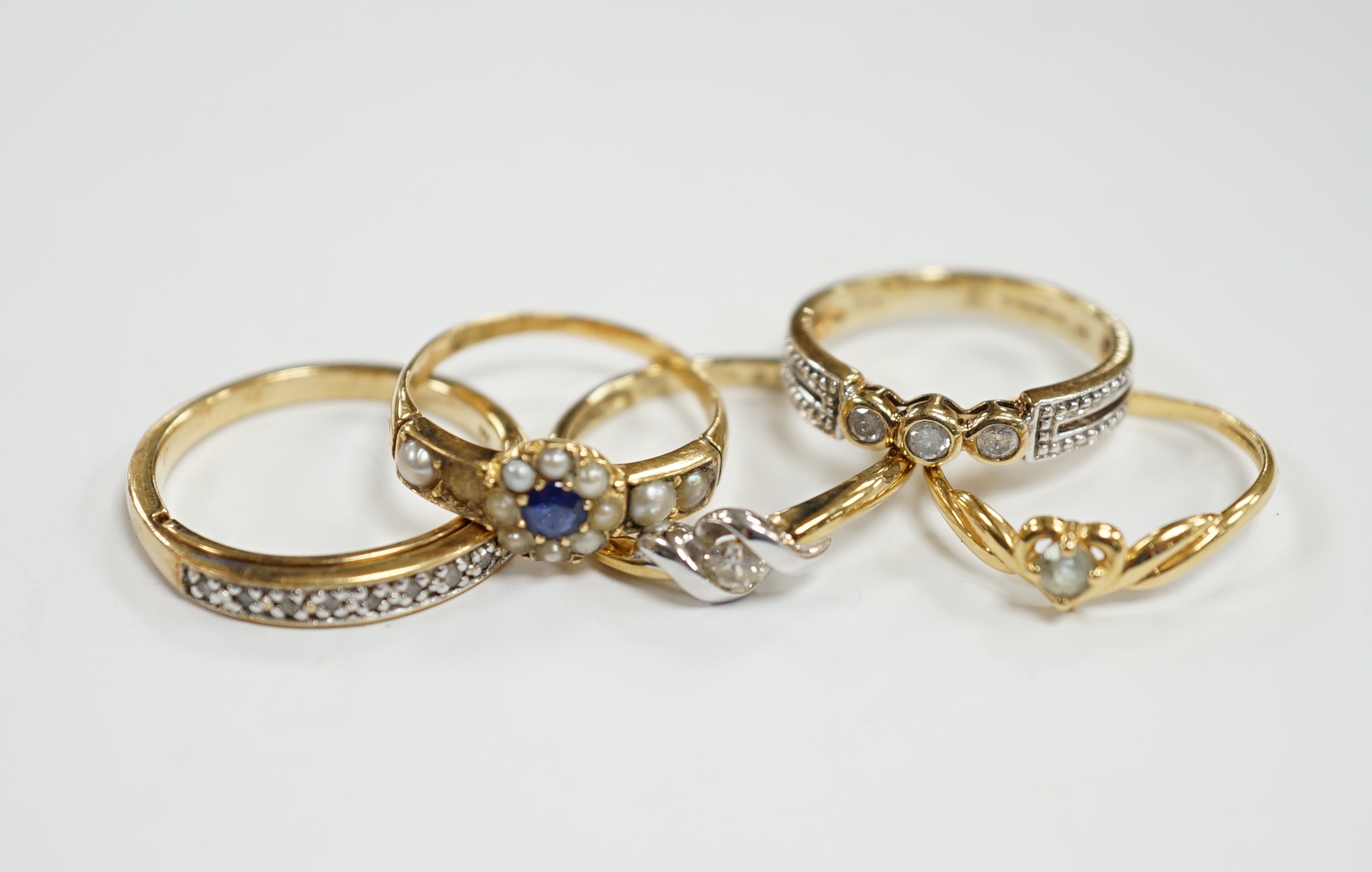 Three assorted modern 9ct gold and diamond set rings, gross 6.5 grams and two other yellow metal and gem set rings.